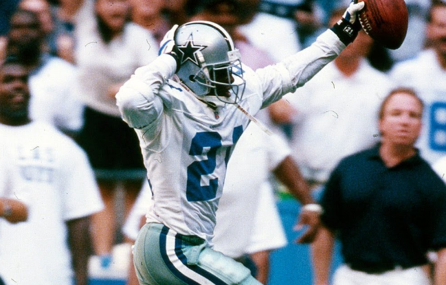 Deion Sanders dancing on his way to a pick 6